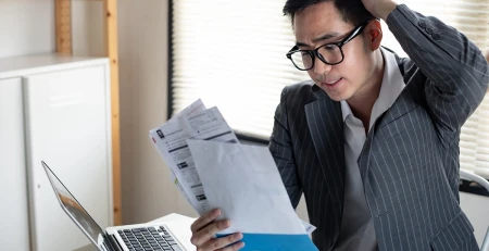 Asian man is stressed and overthink by debt from many credit cards and bills