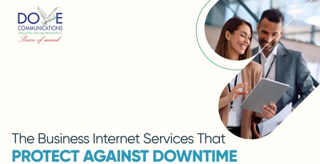 Two professionals smiling and reviewing a tablet, representing business internet services that support seamless business operations and prevent downtime.