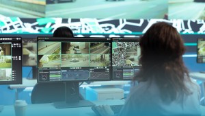 AI Virtual Security Guard Los Angeles control room with a professional monitoring live traffic and surveillance feeds across multiple screens.